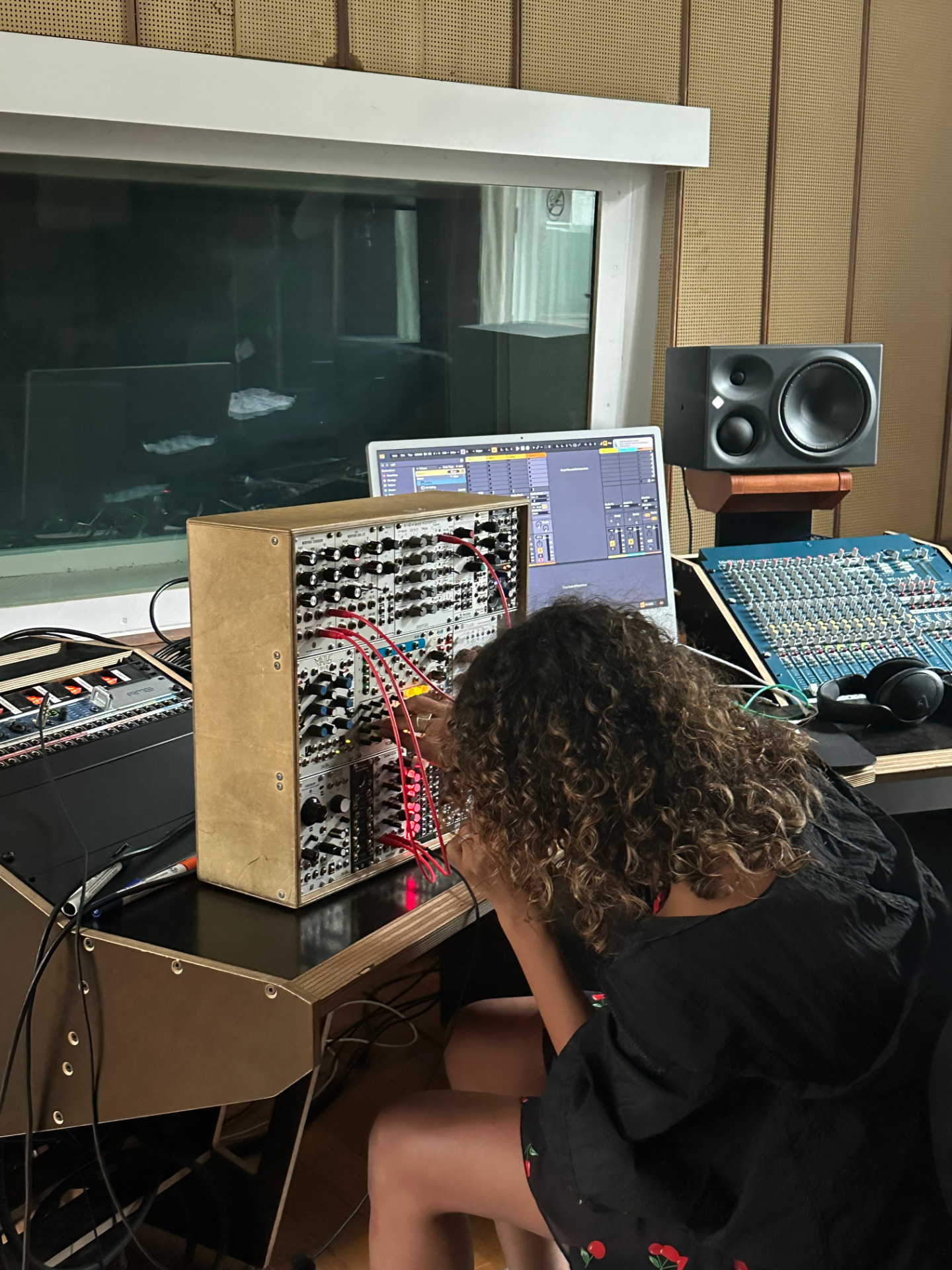 Chaimae Boukri patching a modular synthesiser in a recording studio