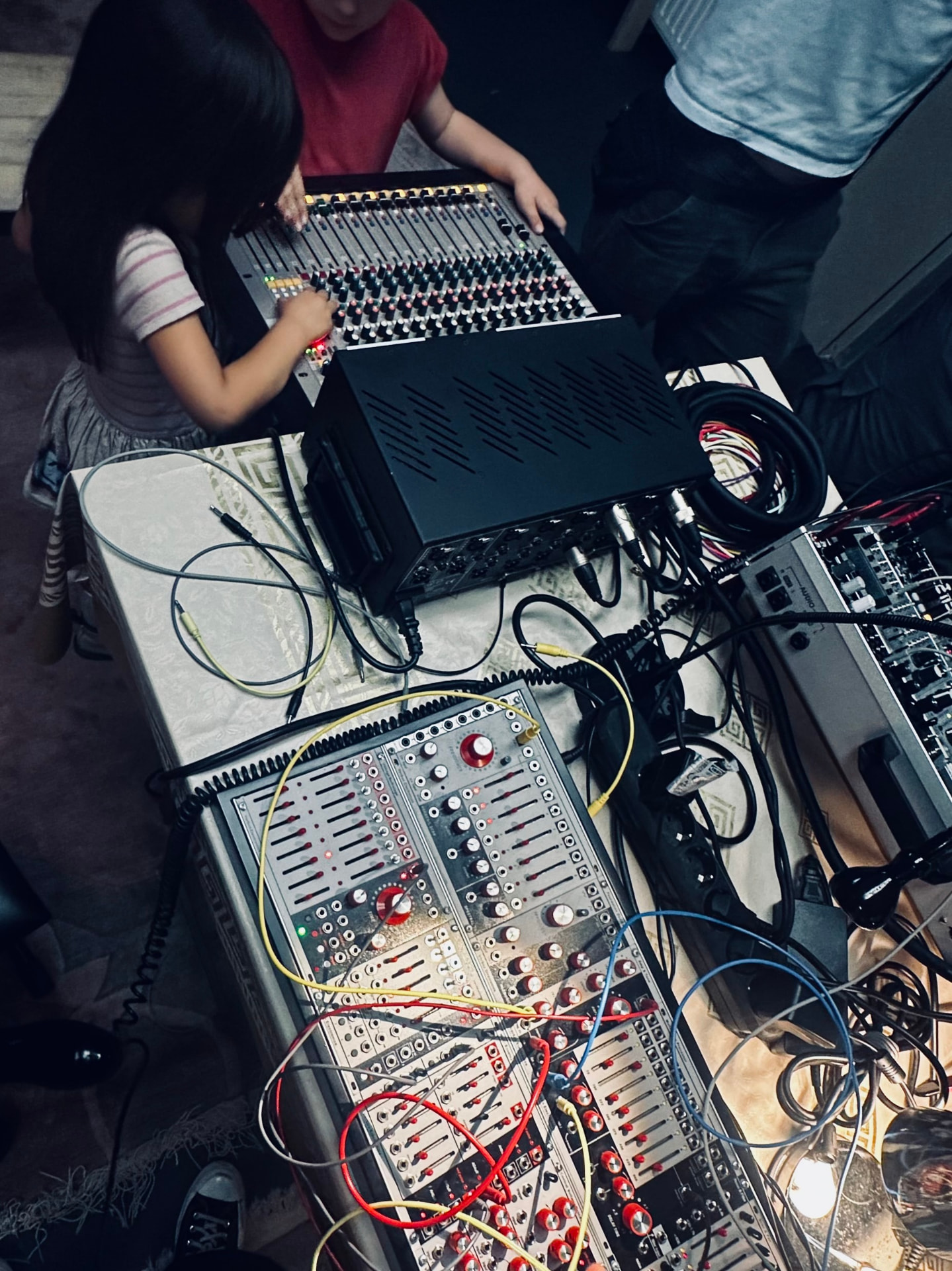 Children exploring the controls of a mixing desk during a sound workshop